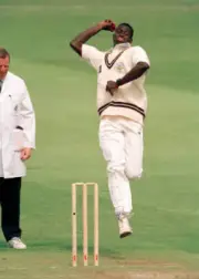 Cameron Cuffy bowling for Surrey during their Benson & Hedges- Old Cricket Photo