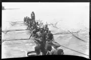Queensland PNG Large group of men, two standing, in an outrigger c - Old Photo