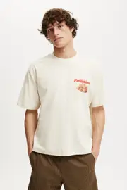 [Cotton On Men] Cotton On Men - Cropped Fit Graphic T-Shirt - Creampuff/mandarin bag S CREAMPUFF/MANDARIN BAG