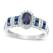 Oval Blue Sapphire and 0.10 CT. T.W. Natural Diamond Sunburst Frame Ring in Solid 14K White Gold