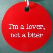 DOG ID TAG OR COLLAR CHARM ETCHED WITH "I'M A LOVER, NOT A BITER" BRAND NEW