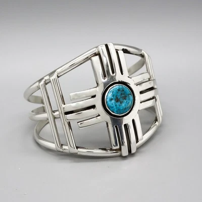 NAVAJO-LARGE STERLING SILVER AND TURQUOISE ZIA CUFF BRACELET by HERBERT BEGAY