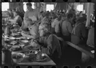 Photo:Lumberjacks eating dinner at camp near Effie, Minnesota