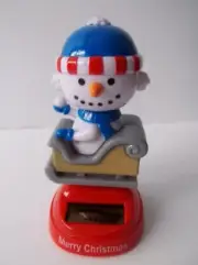 Solar Powered Snowman Bobble Head / On Rocking Snow Sled Holding a Snowball