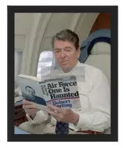 PRESIDENT RONALD REAGAN READING "AIRFORCE ONE IS HAUNTED" 8X10 FRAMED PHOTO