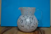 Glass pink spatter pitcher with clear handle, very solid, very pretty.