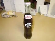 1 FULL 10 OZ. BOTTLE OF " COCA COLA " COKE