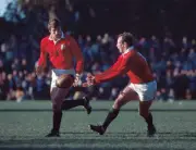 Dusty Hare passes to his teammate David Irwin of the British Lion - Old Photo