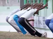 West Indies fast bowler Courtney Walsh stretches with team-mates b- Old Photo