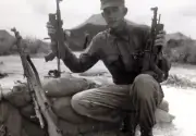 Vietnam War Photos -- Soldier With Capture VC Weapons