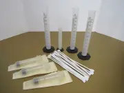 Lot 25 ml (1), 100 ml (3) Plastic Graduated Cylinders, 30cc Syringes (3), Spoons