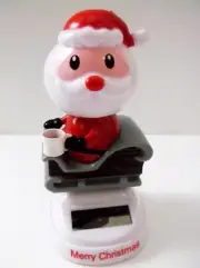 Solar Powered Santa Bobble Head / On Rocking Snow Sled Holding A Cup