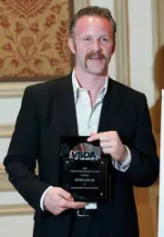 Filmmaker Morgan Spurlock poses backstage after receiving the awar - Old Photo 1