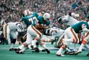 Larry Csonka Miami Dolphins carries the ball and gets hit by Roy - 1974 Photo