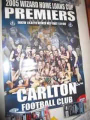 2005 AFL Night Premiership Poster signed by captain Anthony Koutoufides (#2101)