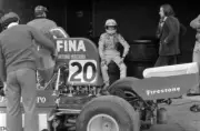 Arturo Merzario sits on a stack of tyres whilst his Williams FW03 - Old Photo 1