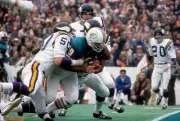 Running back Larry Csonka Miami Dolphins is tackled by Jeff Siemo- 1974 Photo