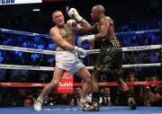 Floyd Mayweather Jr throws a punch at Conor McGregor, Las Vegas 2017 12x8 Photo