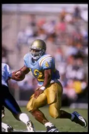 Running back Skip Hicks of UCLA carries the football at the Bruins- Old Photo 1