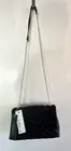 Black shoulder vegan leather handbag with gold chain strap.