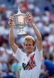 Stefan Edberg of Sweden lifts the trophy after defeating Jim Couri- Old Photo