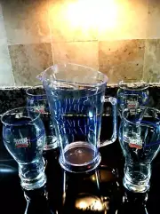 FOUR NEW SAMUEL ADAMS GLASSES WITH A MATCHING SAMUEL ADAMS PITCHER FREE SHIP.