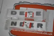 Genuine Land Rover front name plate gloss black DEFENDER decal