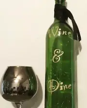 ‘Wine & Dine’ gold sparkle die cut vinyl logo green lighted wine bottle