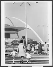 on a crosswalk in front of the arches of the Los Angeles Internati - Old Photo