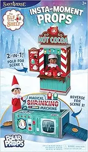 The Elf on the Shelf Insta-Props 2-in-1 Scene Kit with Reversible Pop Out Backdrop - Hot Cocoa Stand and Magic Shrinking Machine Scenes with Accessories