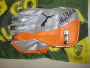 Adam Gilchrist (Australia) signed Puma Wicketkeeping Glove (Orange/Silver) + COA