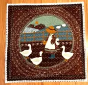 Quilted table topper or wall hanging , brown, 16.5 x 16.5 a girl & geese,