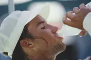 Australian tennis player Patrick Rafter drinking from a bottle of - Old Photo