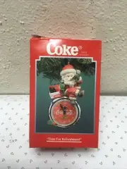 Coca Cola Santa Sitting on a Bottle Cap Clock Drinking a Coke Ornament.#dc