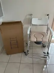 Commode Chair Shower & Toilet.Stainless Steel with Soft Pad seat On Wheels
