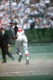 Hank Aaron of the Milwaukee Braves takes a lead at first base duri- Old Photo 1