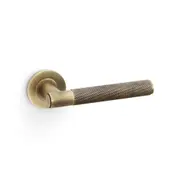 Alexander and Wilks Knurled Spitfire Door Lever on Round Rose Antique Brass