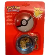 Vintage ￼2 piece ￼Charizard ￼round tin on a key chain 1999 New