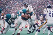 Miami Dolphins' runningback Larry Csonka runs with the ball as a - 1974 Photo
