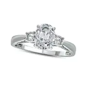 Oval Lab-Created White Sapphire and 0.07 CT. T.W. Diamond Three Stone Ring in Sterling Silver