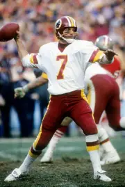 Quarterback Joe Theismann Washington Redskins drops back to pass - 1976 Photo 1