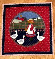 Quilted table topper or wall hanging , blue & ed, about 16 x 16 a girl & geese,