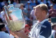 Boris Becker of Germany holds the trophy after winning the Stella - Old Photo 1