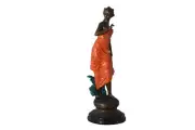 Young lady in orange bronze statue - Size: 7"L x 26"W x 25"H.