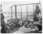 Edge of Regina Jais' patio garden, glass retaining wall, stones an- Old Photo