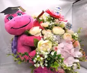 Whimsical Pastel Stuffed Turtle Graduation Centerpiece in Pink Wicker Basket