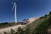 Haydon Paddon (NZL) Hyundai i20 WRC beneath a wind turbine 2014 Rally Old Photo
