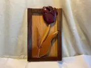 Hand crafted solid wood intarsia wall hanging featuring a single tulip