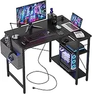 TIQLAB Small L Shaped Desk with Power Outlets - 100x70 cm Corner Computer Desk Writing Table, Reversible Large Storage Shelves, Bookshelf Workstation for Study Play Work Bedroom Home Office, Black