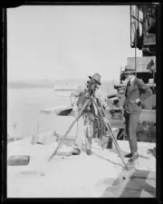 Surveyor looking through survey tool during construction Sydney Har- Old Photo